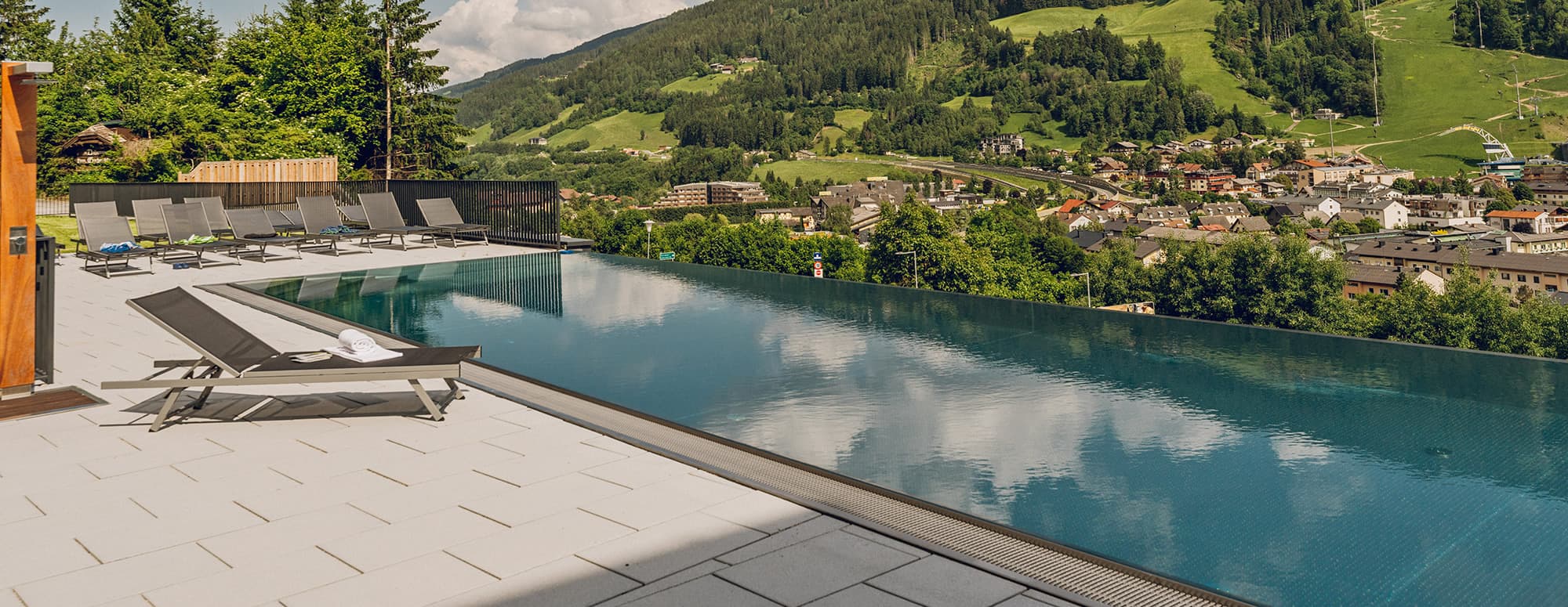 Infinitypool mit traumhaftem Blick über Schladming und die umliegenden Berge der Region Schladming-Dachstein